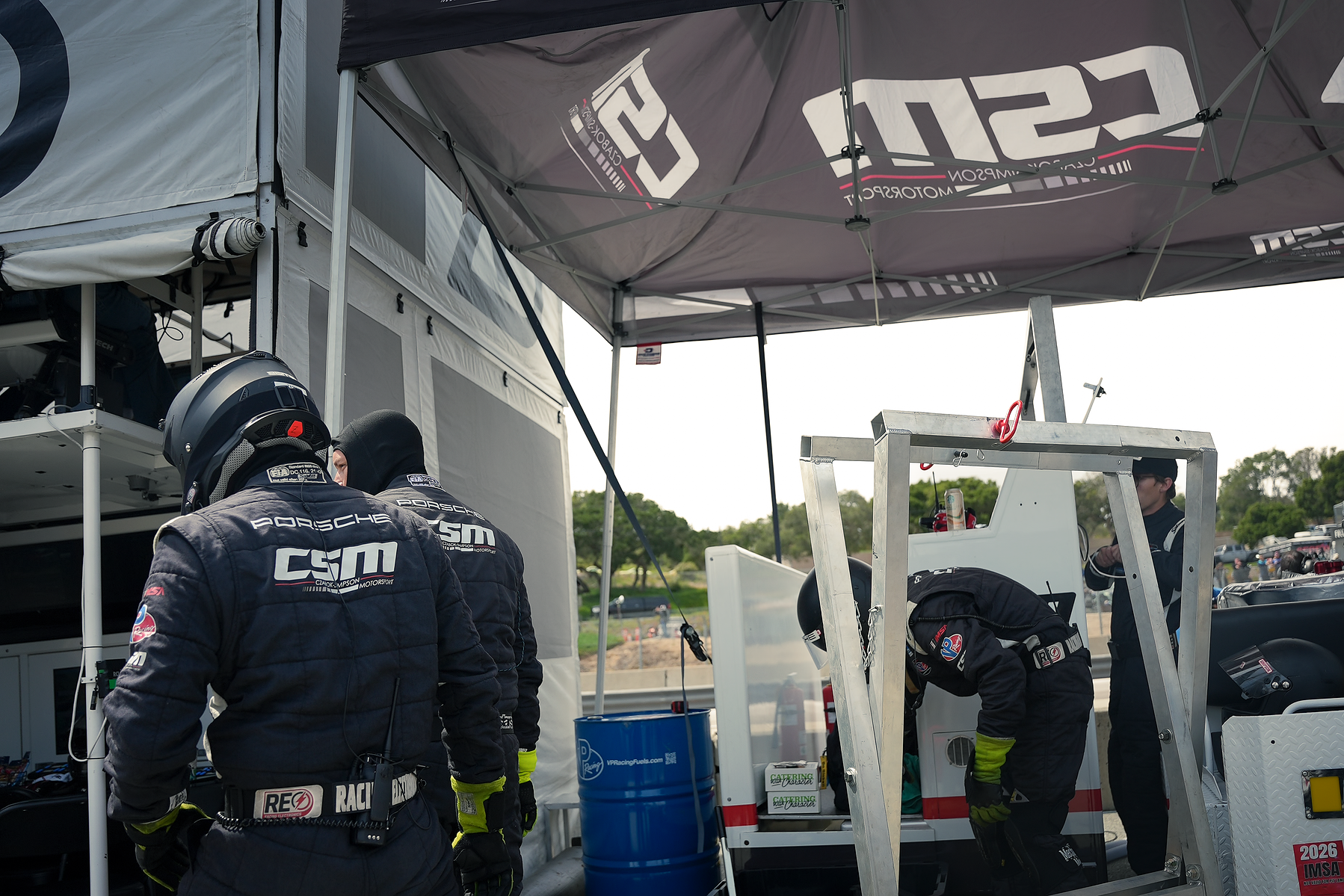 Czabok-Simpson Motorsport crew prepare equipment beneath their canopy at Laguna Seca.