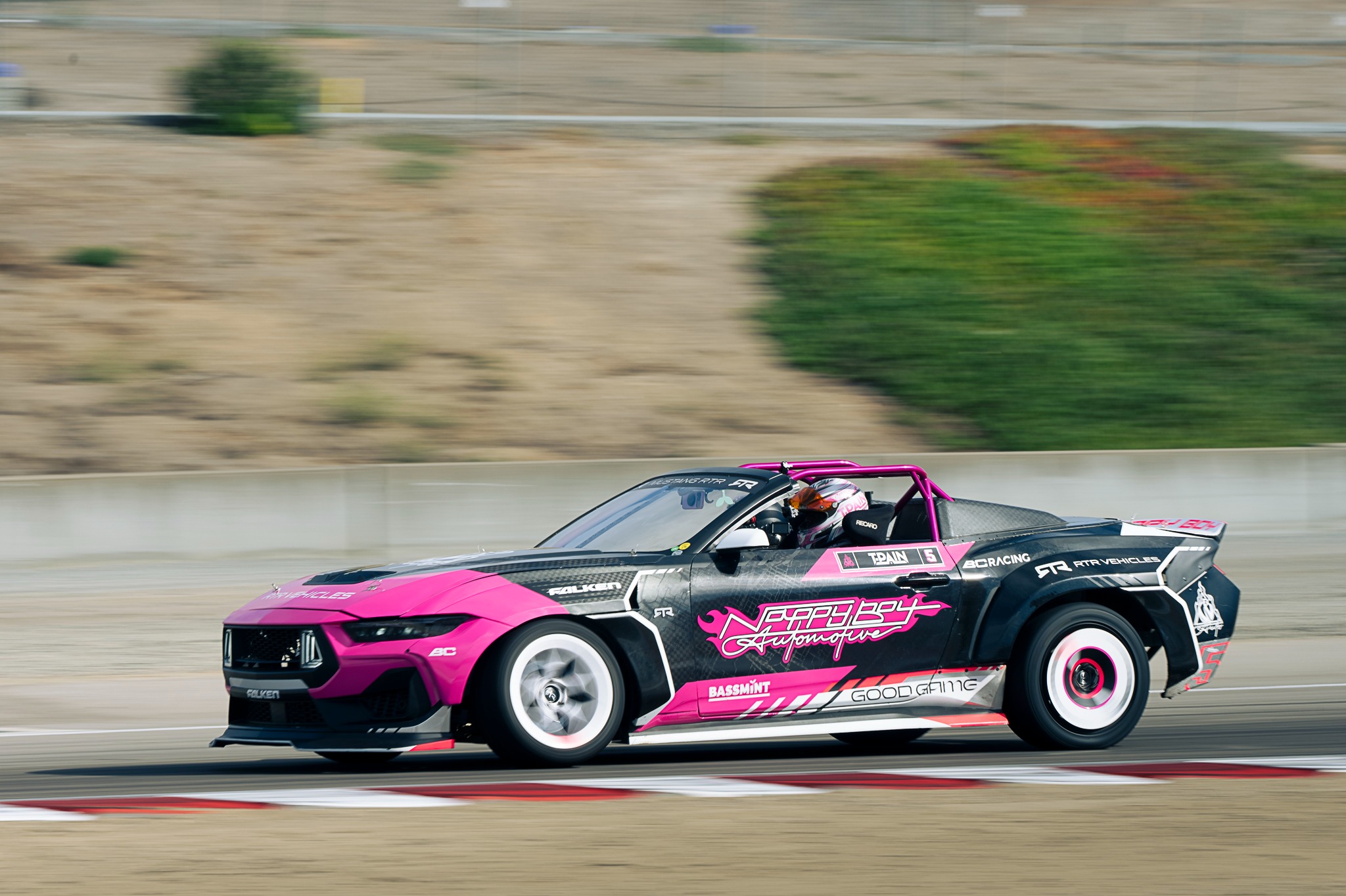 A pink drift car passes in a panning photograph at GRIDLIFE Laguna Seca.